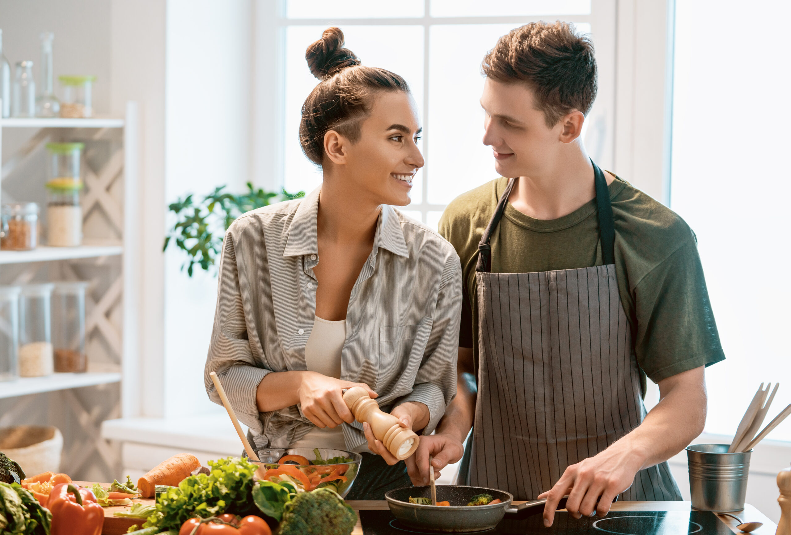 Affordable At Home Third Date Plans for a Romantic and Fun Evening In - couple in kitchen