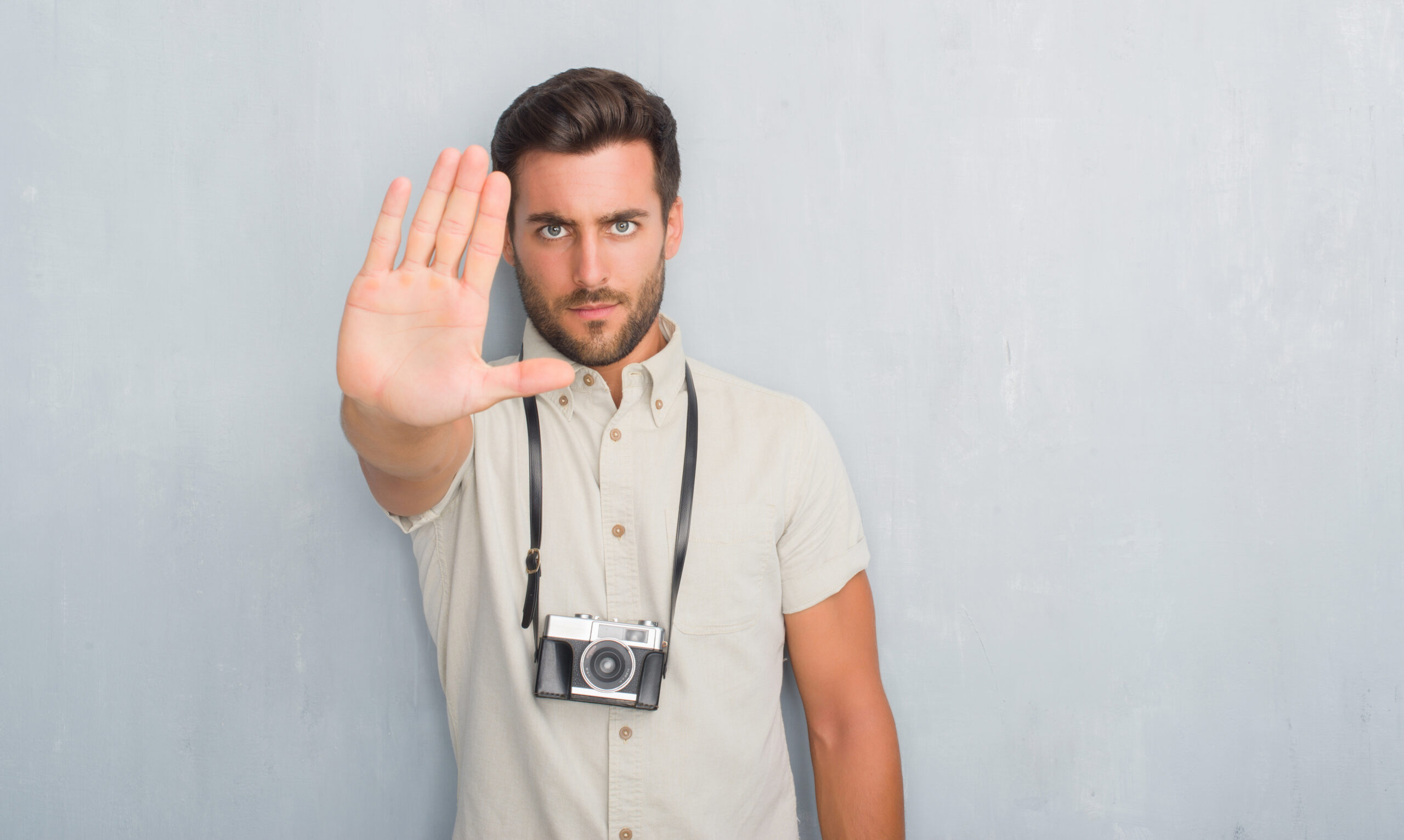 Consent Before Sending Photos - Man holding hand out with camera round his neck